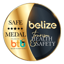 A gold and black medal with the text "Safe Medal" and "Belize Tourism Health & Safety."